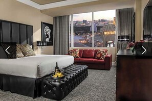 Relax in this stylish room with a large bed, a comfortable sofa, and a city view.