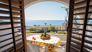 A balcony with a table set for two, overlooking a coastal view. - Apartment 250 meters from the beach with sea view (Provincia di Agrigento)
