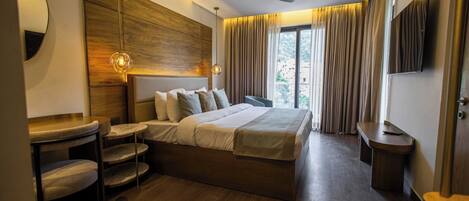 Una habitación de hotel moderna con una cama grande, un escritorio y un ventilador de techo.
