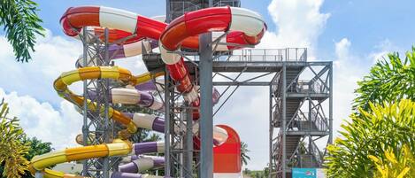 A water park with multiple water slides and a central tower structure.