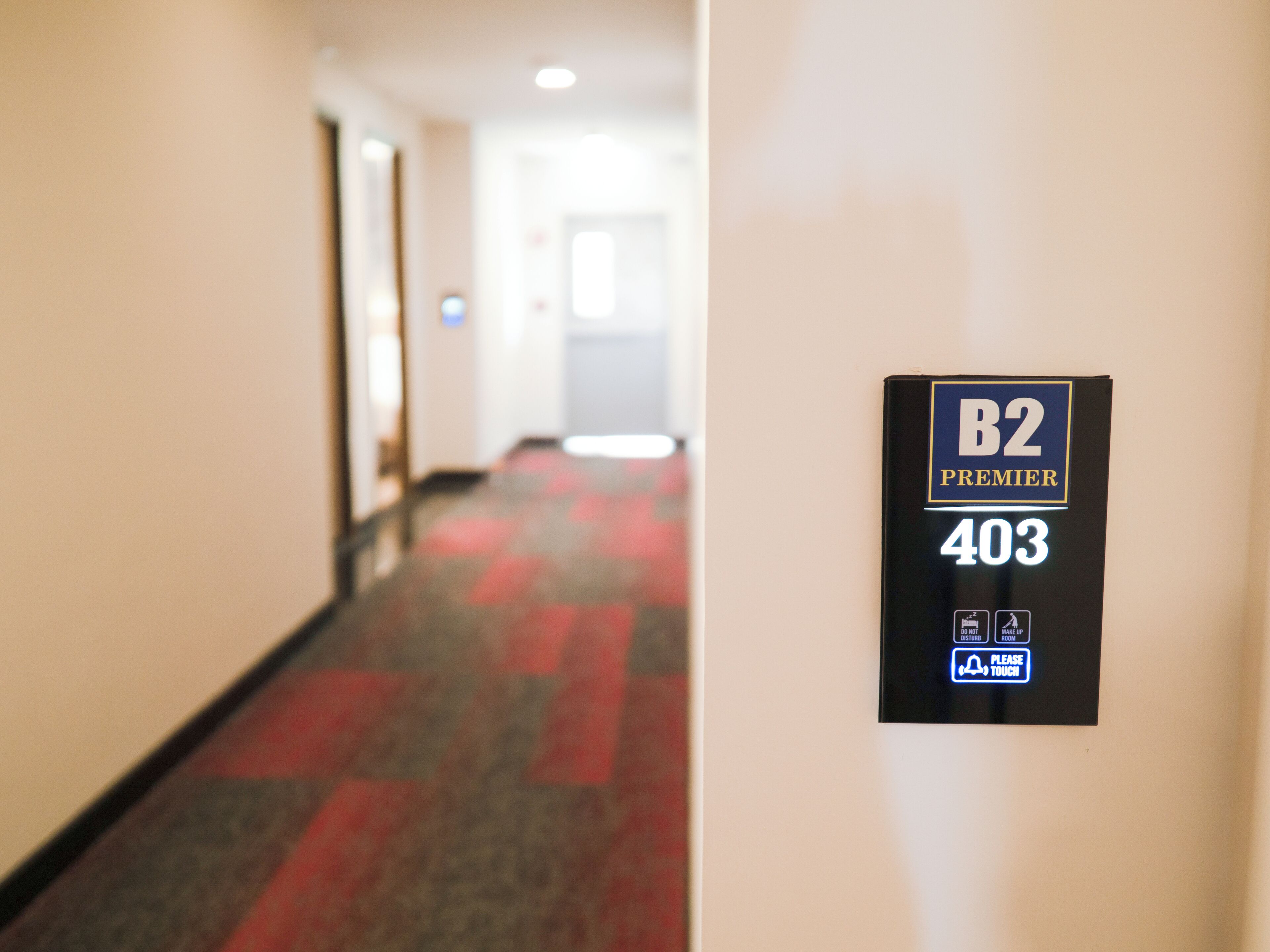 A hotel corridor with a sign indicating room B2 Premier 403.