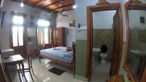 A room with a bed, a desk, a chair, a wardrobe, a bathroom with a toilet and sink, and a ceiling fan. - Private Cozy Spacious Studio in Colombo (Colombo)