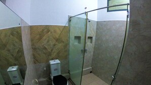 A bathroom with a sink, two toilets, and a glass shower enclosure. - Private Cozy Spacious Studio in Colombo (Colombo)