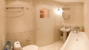 Apartment | Bathroom | Bathtub, hair dryer, slippers, towels - Apart Kiev Derevlianskaya 21A (Kyiv)