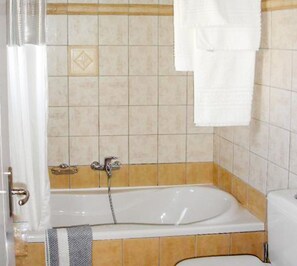 Bathtub, hair dryer, towels, soap