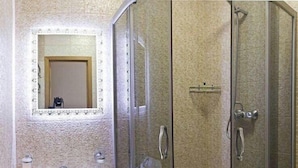 A bathroom with a glass-enclosed shower, a pedestal sink, and a mirror with a decorative frame. - Apart Kiev Starokievskiy pereulok 5-1 (Kyiv)