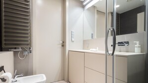 A modern bathroom with a glass shower enclosure, a white sink, and a mirror above the vanity. - 2- bedroom Apartment near Main Market Square (kraków)
