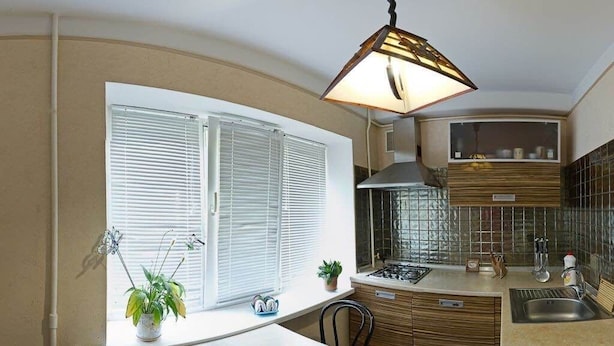 A compact kitchen with a window, a stove, and a sink. - Apart Kiev Starokievskiy pereulok 5-2 (Kyiv)