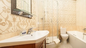 A bathroom with a shower, toilet, and sink. - Apart Kiev Zlatoustovskaya 50-2 (Kyiv)