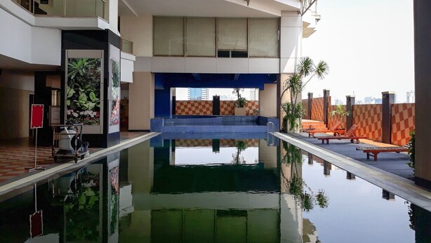 A modern indoor pool with a clear view of the cityscape through the windows.