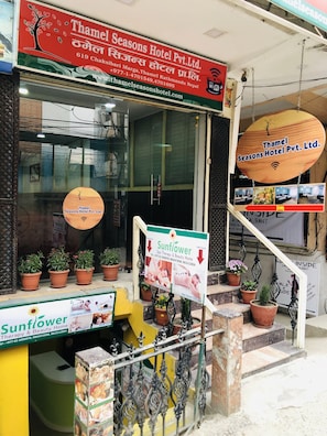 A hotel entrance with a sign for Thamel Seasons Hotel Pvt. Ltd., a spa, and a restaurant.