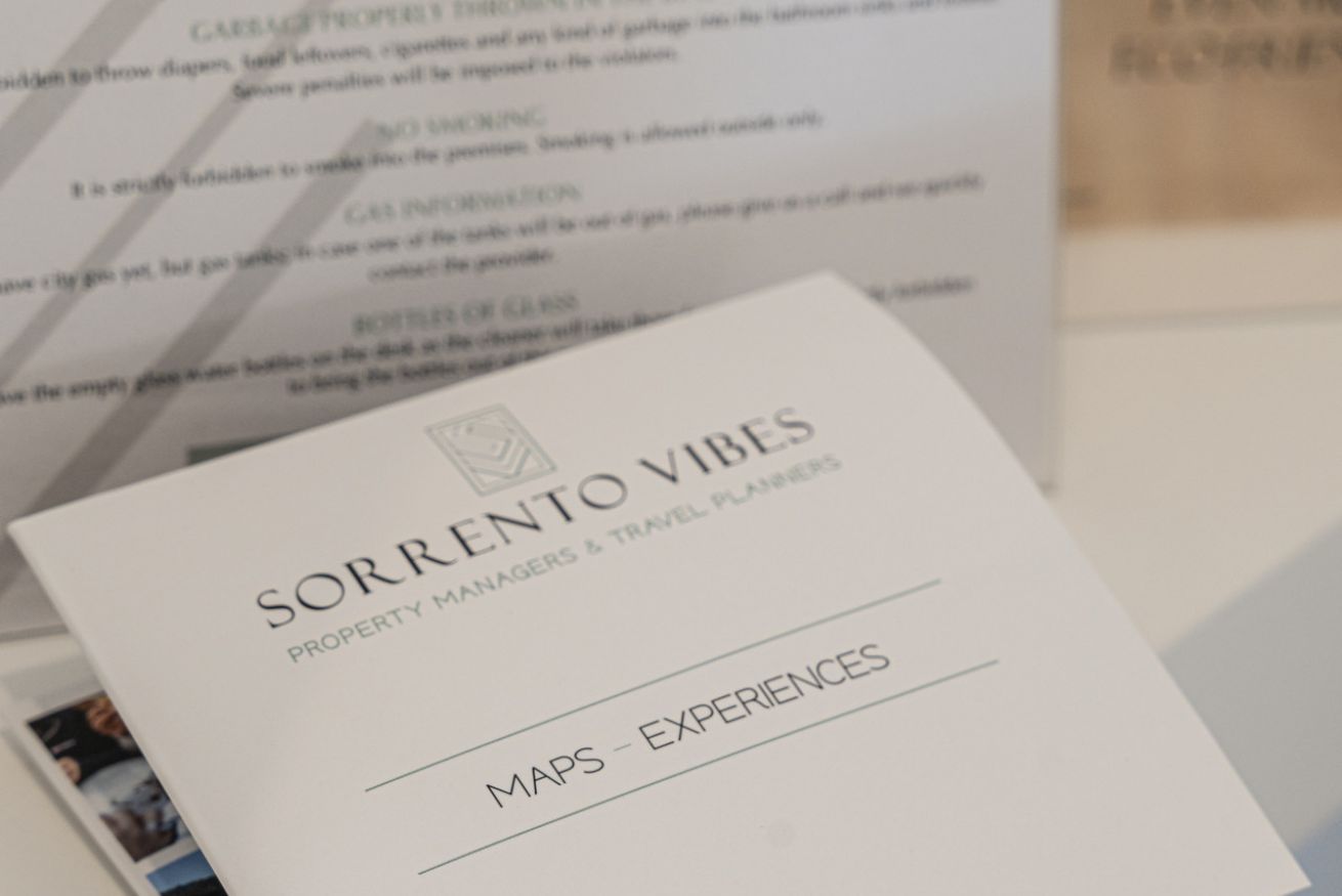 A business card for 'Sorrento Vibes' with the tagline 'Property Managers & Travel Planners' and a section titled 'Maps - Experiences'.