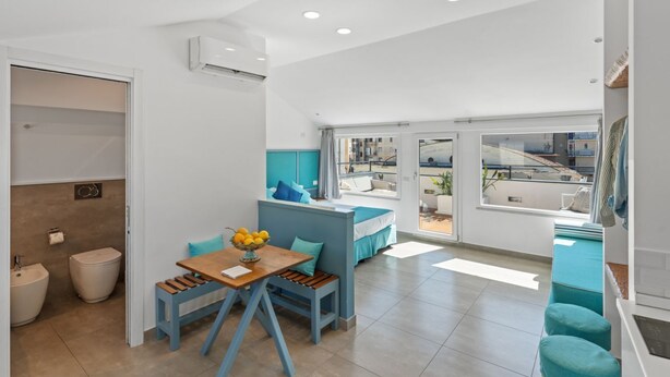 Una cocina moderna con comedor, un banco integrado y vista a la ciudad.