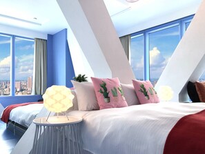 A modern hotel room with a large bed, a bedside table with a lamp, and a city view through large windows. - San Jo Hostel (Kaohsiung)