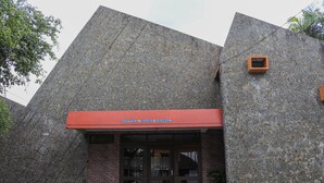 A building with a stone facade and a red awning.