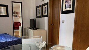 A compact room with a glass table, a bed, a desk, and a wardrobe. - Anzolo Palace (Venice)