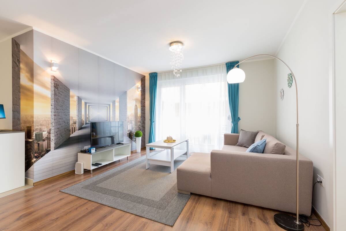 A modern living room with a sofa, TV, and a coffee table.