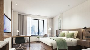 A modern hotel room with a large bed, a desk, and a chair. There is a window with a city view, a lamp, and a small table with a plant. - GreenTree Inn Nanchang Honggutan New Area Cuiyuan Road Subway Station Business Hotel (Nanchang)