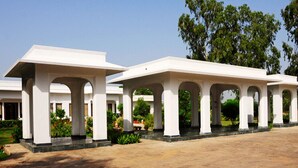 A series of white, freestanding structures with arches, likely part of a hotel or resort.