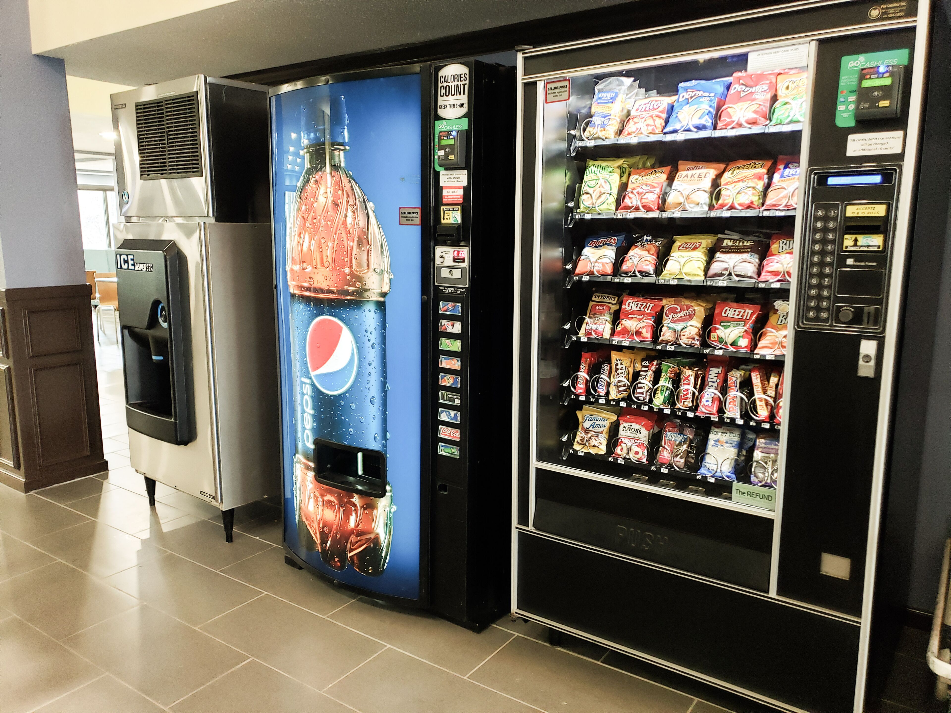 A vending machine with a Pepsi logo and a water dispenser.