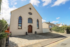 Traditional building with a central entrance and arched windows.