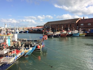 Boats docked at a picturesque pier overlooking the calm harbor.