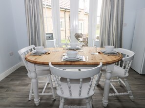 Enjoy meals in this cozy dining area with a round table and four comfortable chairs.