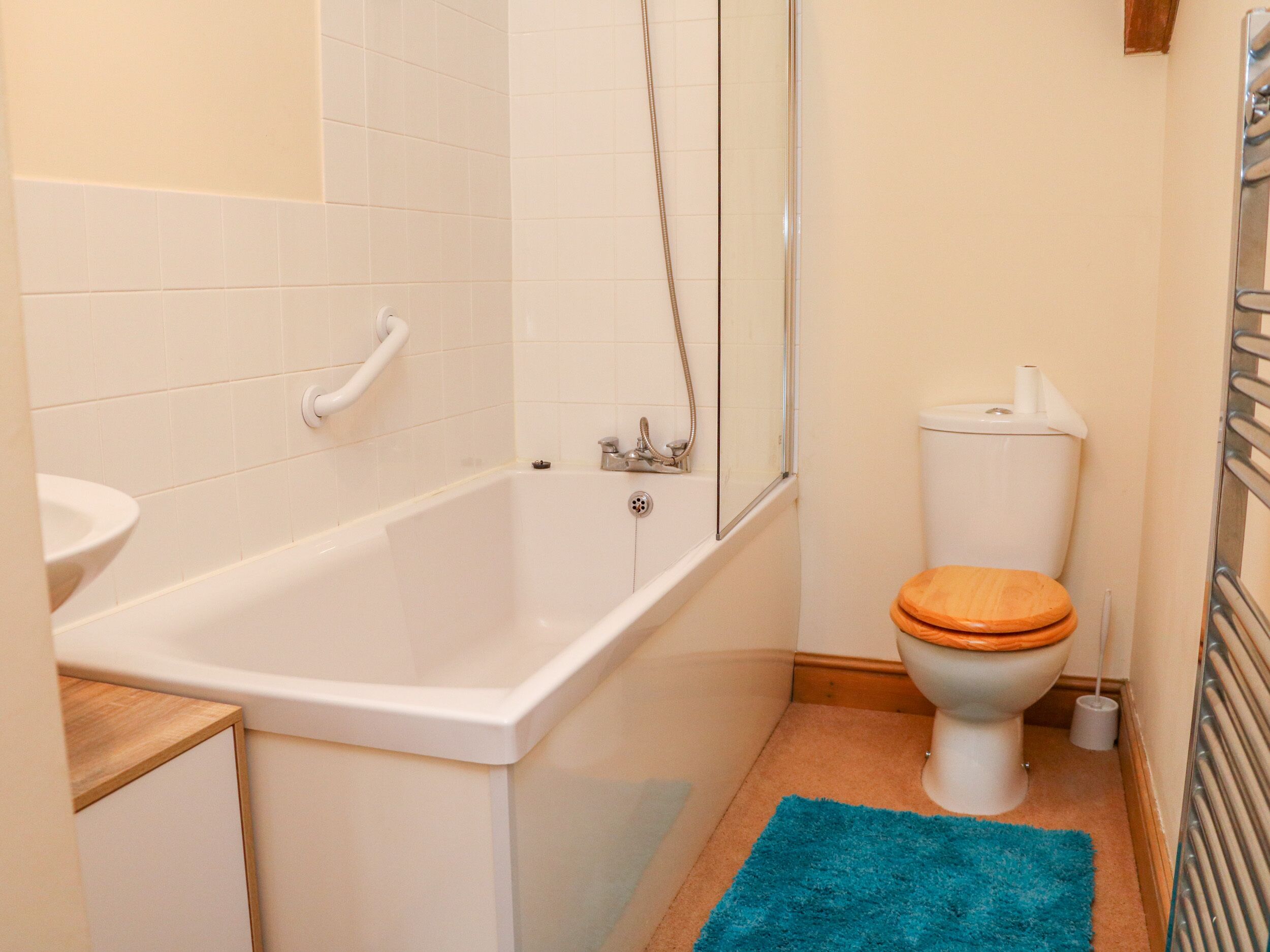 A bathroom with a bathtub, toilet, and sink.
