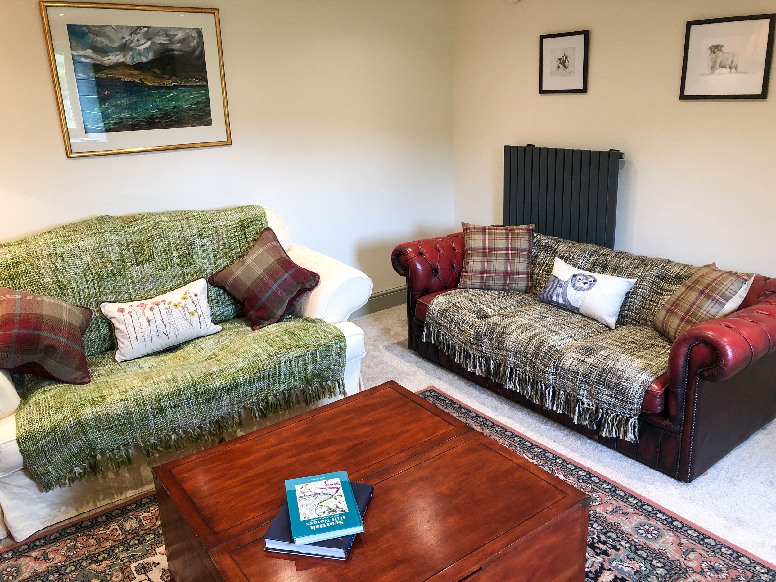A living room with two sofas, a coffee table, and a rug.