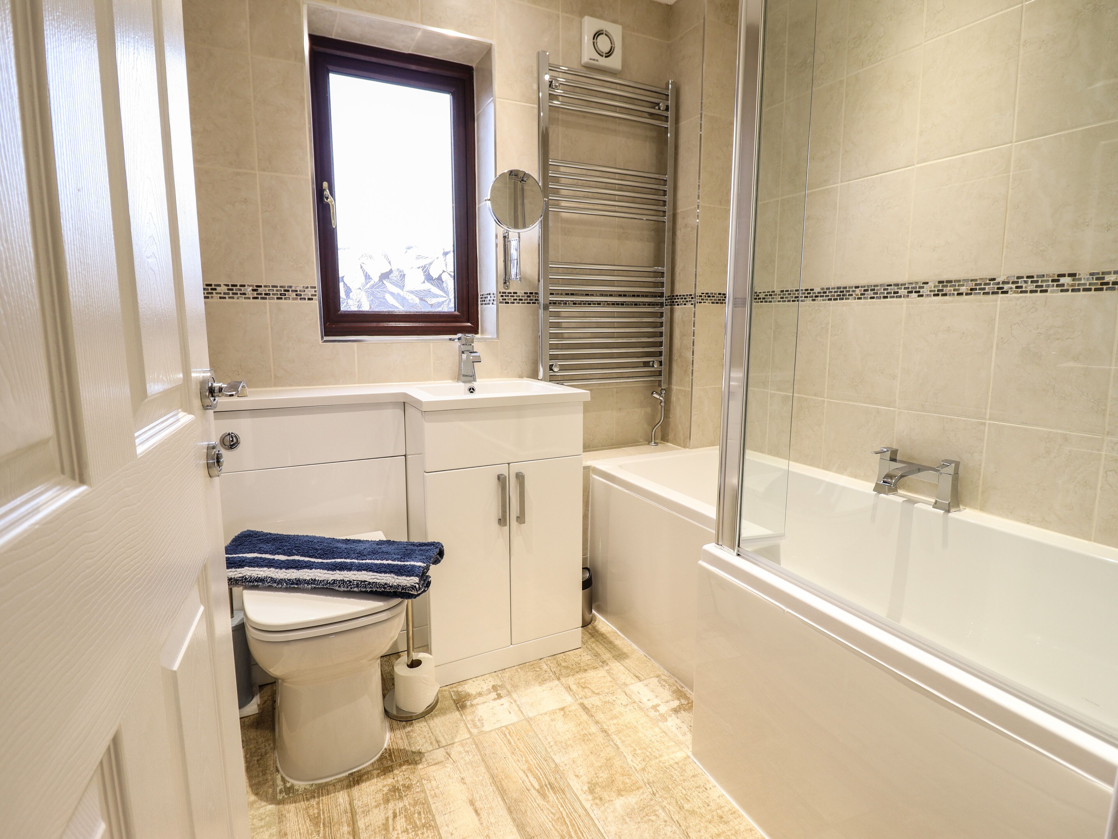 Een badkamer met toilet, wastafel en douche.