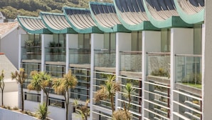 A modern building with multiple balconies, large windows, and a green roof. - The Lookout (Bideford)