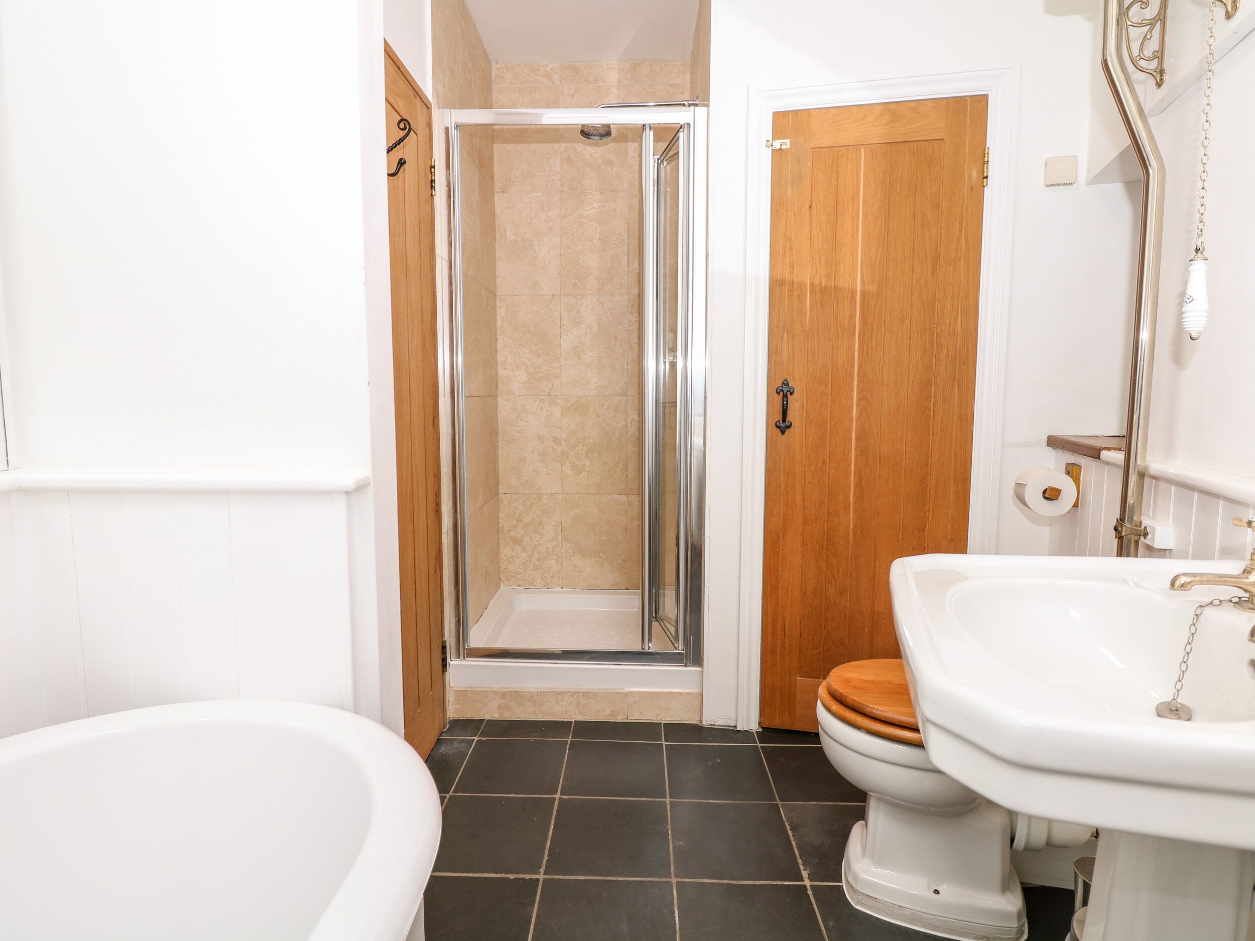 A bathroom with a shower, toilet, and bathtub.