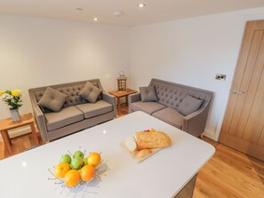 Relax in this stylish living room with two sofas, a coffee table, and a side table, perfect for unwinding.