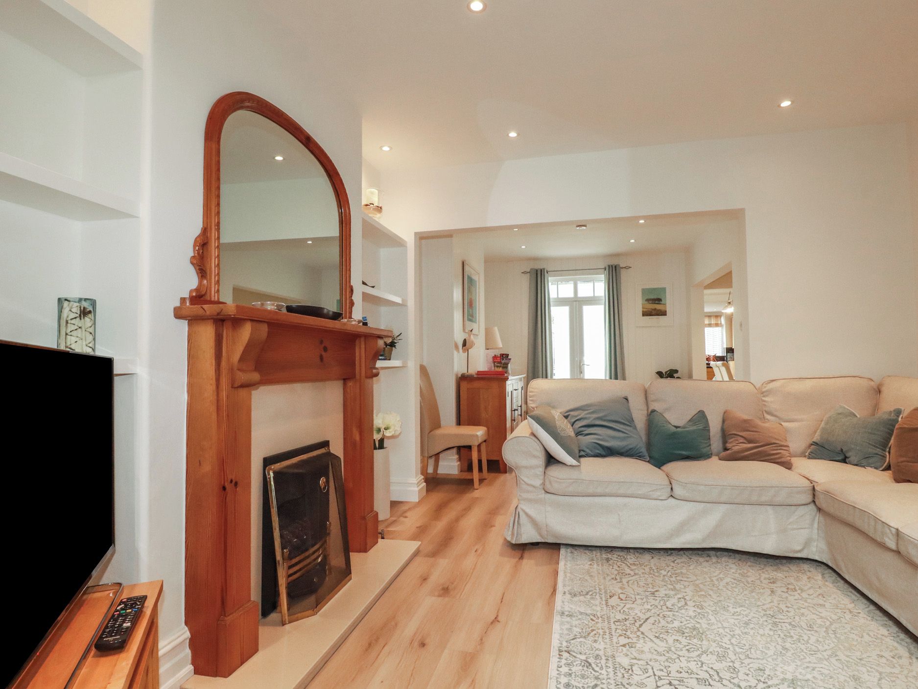 A living room with a fireplace, a sofa, and a television.