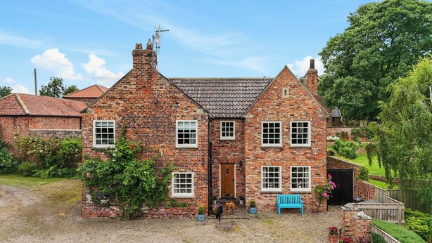 A traditional brick house with a central entrance, multiple windows, and a small porch area. - Manor Cottage (Northallerton)