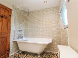 A bathroom with a freestanding bathtub, a shower, and a toilet. - Coth Skyber (Hayle)
