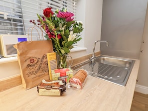 Enjoy a warm welcome with a selection of teas, fresh flowers, and sweet treats.