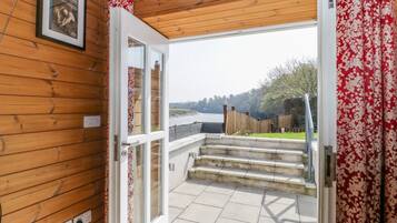 Enjoy a serene view of the landscaped outdoor area from the comfort of this cozy space.