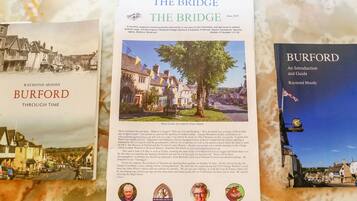 A book titled 'BURFORD THROUGH TIME' by Raymond Moody, featuring historical photographs of Burford.