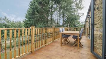 Enjoy a tranquil outdoor space with a table and chairs overlooking the surrounding landscape.