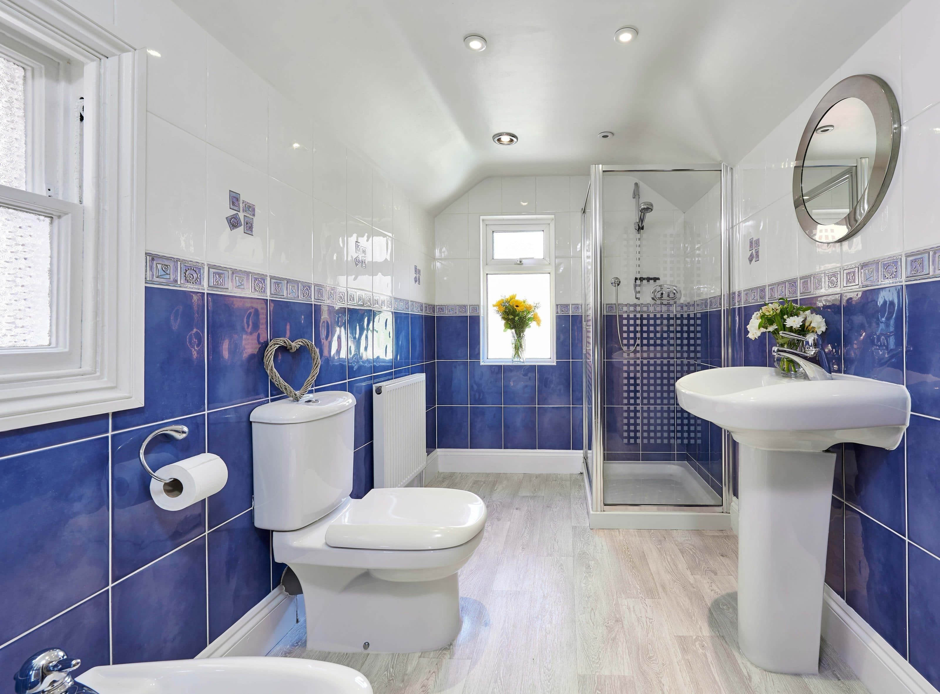 A bathroom with a toilet, sink, and shower.