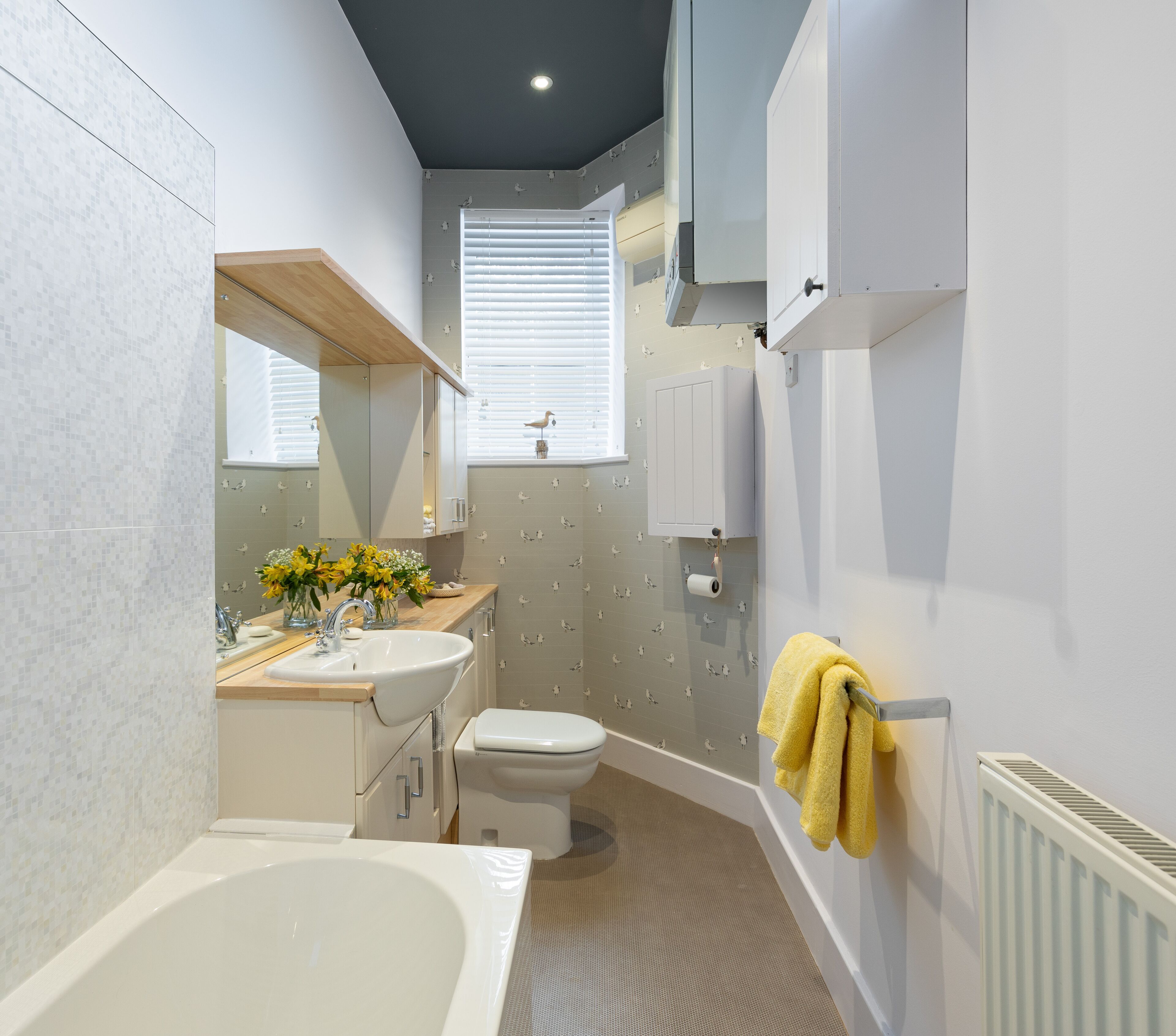 A modern bathroom with a bathtub, toilet, sink, and shower.