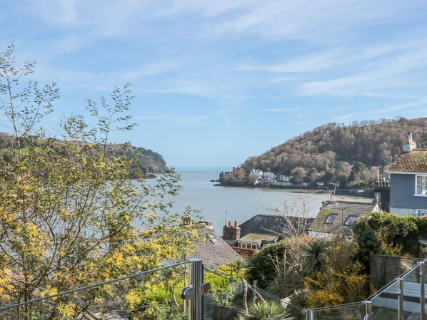A coastal town with buildings on a hillside overlooking the sea. - Estuary View (Dartmouth)