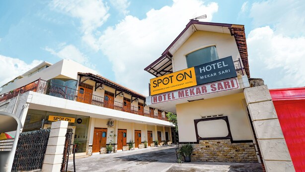 A hotel named "Spot On Hotel Mekar Sari" with a modern design, featuring a two-story structure, a covered entrance, and a visible balcony. - SPOT ON 2011 Hotel Mekar Sari (Surakarta)