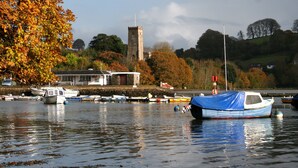 A harbor with boats, a tower, and autumn foliage. - Hilltop (Totnes)