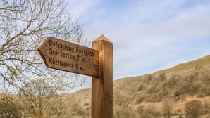 A wooden directional signpost with distance markers for Dales Way Footpath, Starbotton, and Kettlewell. - Dale View (Skipton)