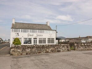 A two-story building with a sign reading "Paul Jones Bar & Grill". - Mardan (Dumfries)