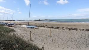 A beach with boats and a clear sky. - The Pink House (Rhosneigr)