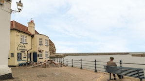 A coastal pub named 'Cod & Lobster' with outdoor seating and a view of the sea. - Salmon Cottage (Saltburn-by-the-Sea)