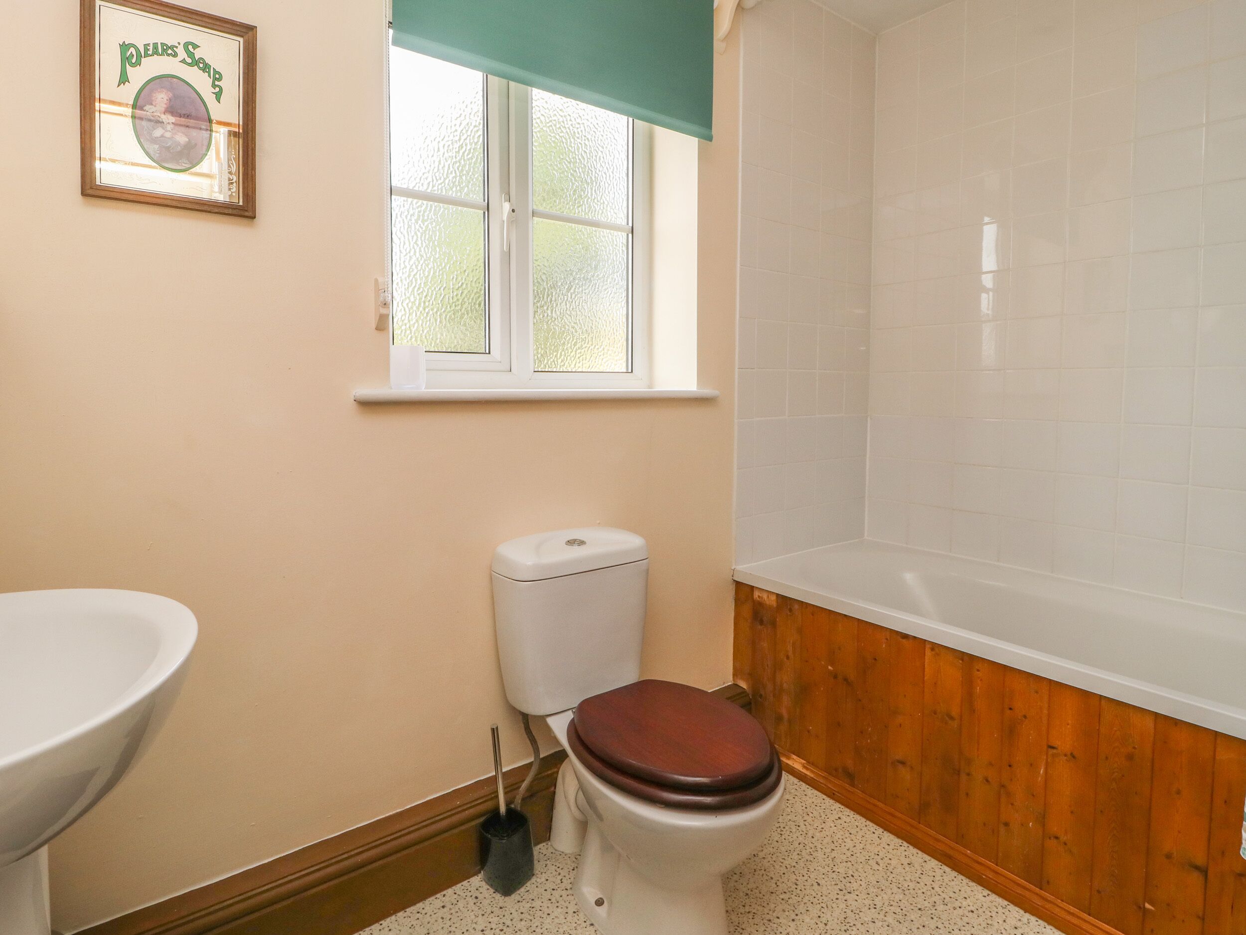 A bathroom with a toilet, sink, and bathtub.